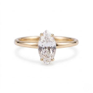 A gold ring featuring a marquise-cut clear gemstone in a four-prong setting, shown against a plain white background - J.Collins Jewelry