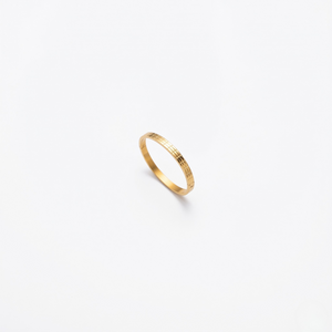 Gilded gold bracelet with a sleek, textured design on a plain white background.