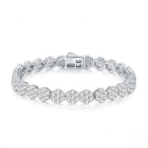 Sterling silver tennis bracelet featuring floral cluster links with micro-paved cubic Moissanite crystals and a secure box clasp shown on a plain white background by J.Collins