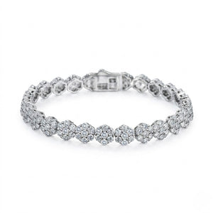 Sterling silver tennis bracelet with circular floral cluster cubic Moissanite links and a secure box clasp angled on a plain white background by J.Collins