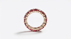 14K yellow gold ring with lab-created ruby gemstones in an eternity band style
