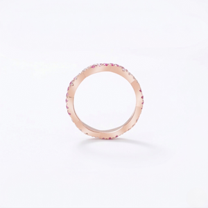 14K rose gold ring with lab-created rubies in a minimalist design on white background
