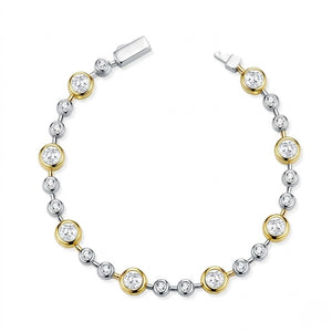 Two-tone gold and sterling silver station bracelet set with bezel-set round cubic Moissanite crystals unclasped in a circular layout on a plain white background by J.Collins