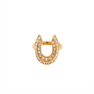 Gold horseshoe ring with embedded clear gemstones on a plain background.