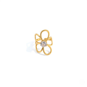 Gold orchid-shaped ring with a central diamond setting against a white background