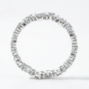 18K white gold eternity band with lab diamonds in a prong setting, viewed from the side against a white background