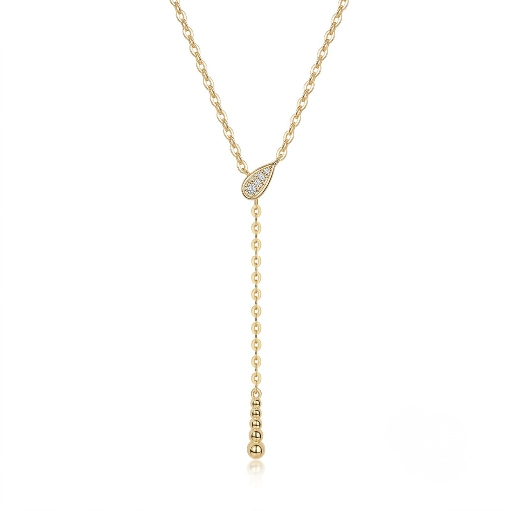 A delicate gold Y-necklace featuring a teardrop-shaped pavé pendant and a long drop chain ending in a small bead, shown on a solid white background - J.Collins Jewelry
