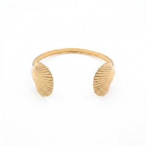 Gold bracelet with shell-like designs on a white background. J.Collins Jewelry