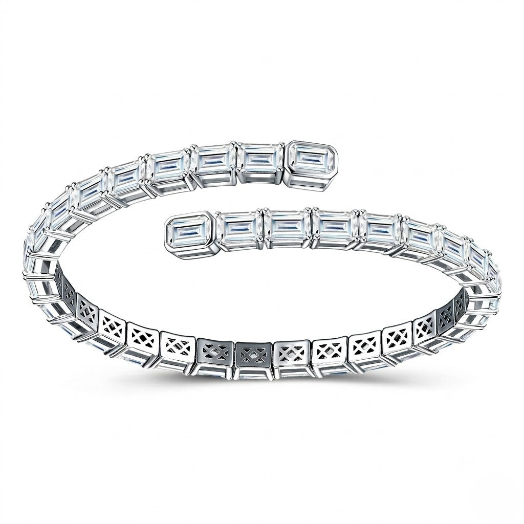 Flexible sterling silver open wrap tennis bracelet handset with emerald-cut cubic Moissanite crystals shown on a plain white background by J.Collins