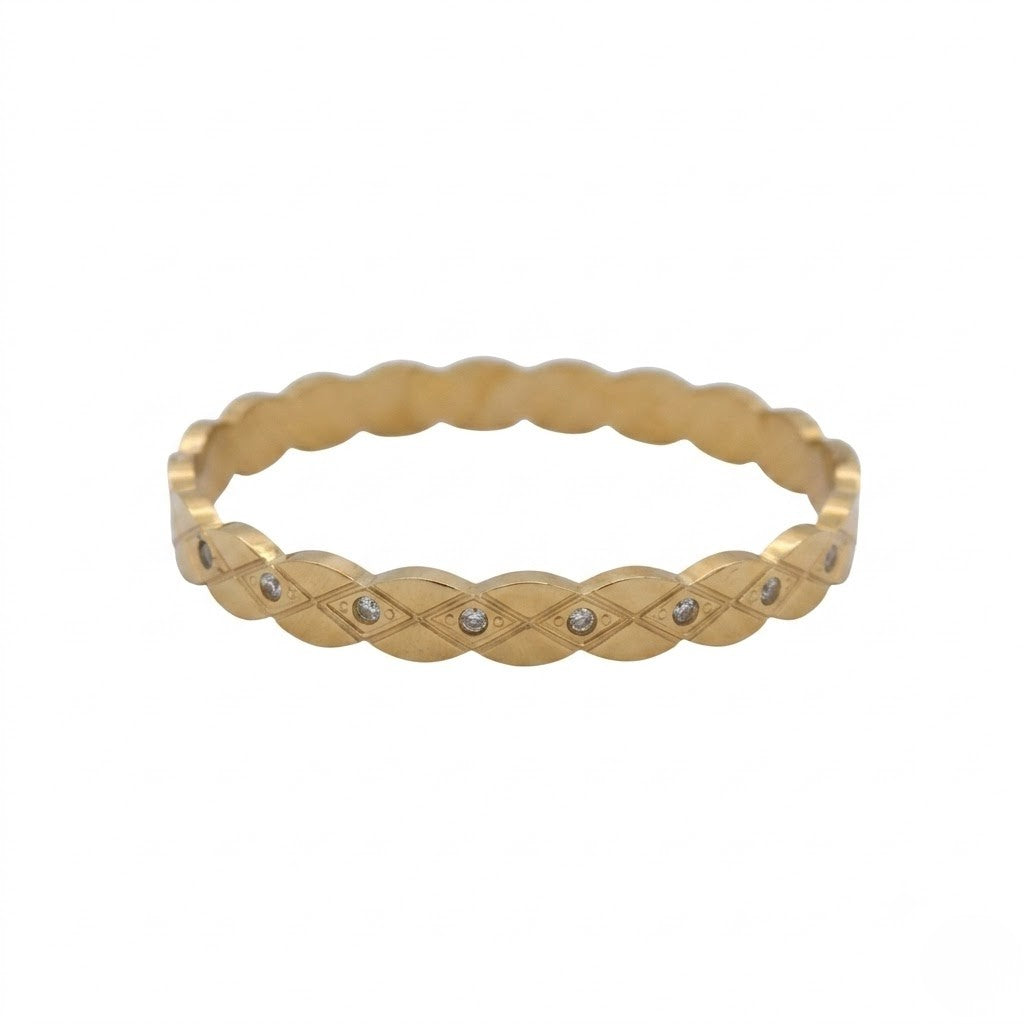 Gold bracelet with braided design and small stones on a white background
