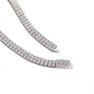Double-row sterling silver tennis bracelet set with round cubic Moissanite crystals showing clasp detail on a plain white background by J.Collins