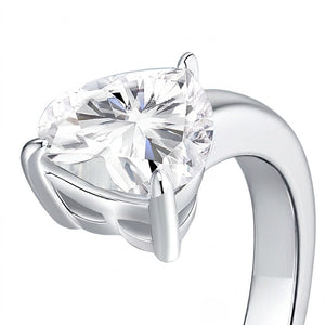 Macro close-up view of a sterling silver ring band highlighting a brilliant heart-cut prong-set cubic Moissanite gemstone by J.Collins