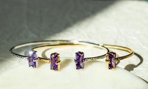 Gold bracelet with purple gemstones on a textured surface - Duara Cuff Bracelet - JCollins Jewelry