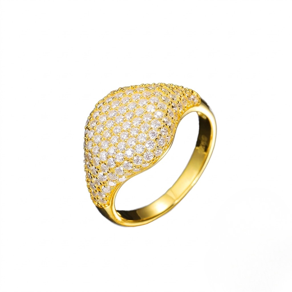 Gold pavè dome signet ring encrusted with clear cubic Moissanite crystals against a white background. J.Collins