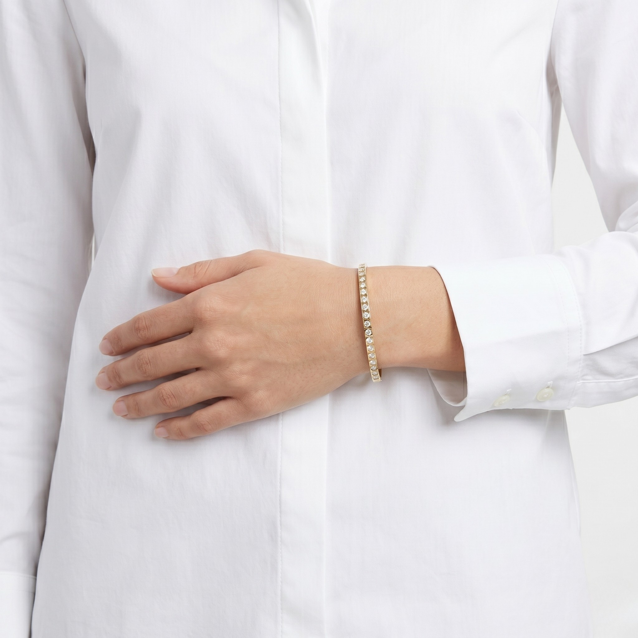 Person wearing a white shirt with a bracelet on a plain background-J.Collins Jewelry
