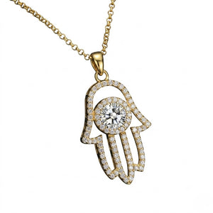 Gold Hamsa hand pendant necklace set with pave moissanite and a round center stone shown on a plain white background by J.Collins