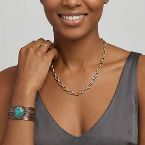 Model Tiffany wearing a two-tone oval link chain necklace paired with a western-style turquoise feather cuff bracelet | J.Collins Jewelry