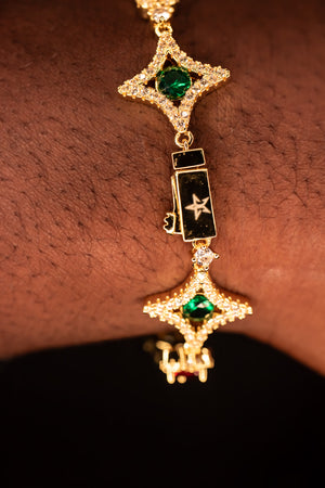 Gold bracelet with green gemstones on a wrist- Multicolor-Gemstone-Bracelet JCollins-Jewelry