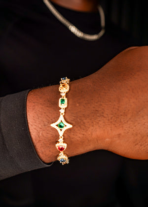 Gold bracelet with gemstones on a wrist against a dark background- Multicolor-Gemstone-Bracelet JCollins-Jewelry