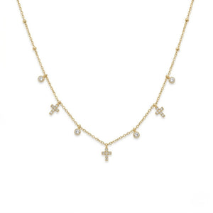 Gold charm necklace featuring dangling pave diamond crosses and bezel-set round crystals isolated on a white background | J.Collins Jewelry
