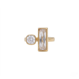 Modern gold open cuff style ring featuring a bezel-set round diamond and a vertical baguette-cut crystal isolated on a white background | J.Collins Jewelry