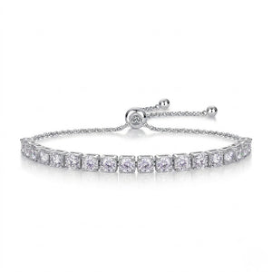 A tennis bracelet with a row of clear square-cut stones, featuring an adjustable sliding clasp with ball ends on a white background.