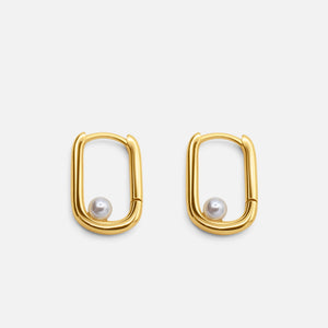 Gold hoop earrings with pearl centers on a white background - Selene Pearl Hoops - JCollins Jewelry