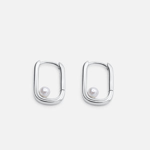 Pair of silver hoop earrings with pearl centers on a light gray background - Selene Pearl Hoops - JCollins Jewelry