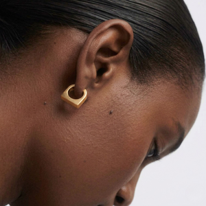 Woman wearing gold hoop earrings on a white background-J.Collins Jewelry