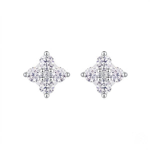 A pair of silver stud earrings featuring a four-stone cluster design in a diamond shape, set against a plain white background. J.Collins Jewelry