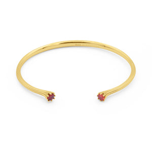 Gold bracelet with red gemstones on a white background - Valora Cuff - JCollins Jewelry