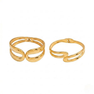 Gold Omega Flow Bracelet set with modern, swirling design on white background