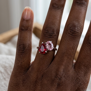 14K white gold ring with red and pink gemstones on a hand
