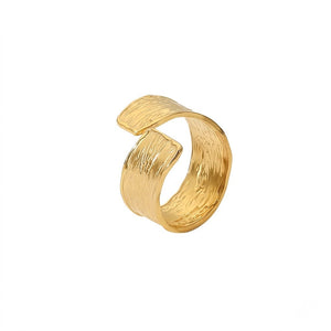 Gold textured coil ring on a white background