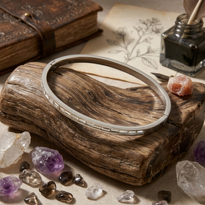 Silver Channel Stone Bracelet on rustic wood, surrounded by crystals and nature-themed background items
