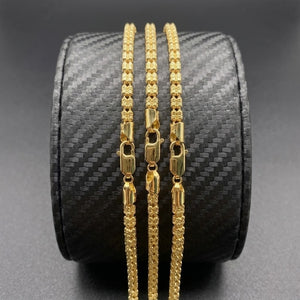 Vermeil gold link necklaces with 4mm width displayed on a black textured jewelry holder