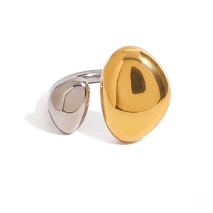 Two-tone ring with large polished gold and small silver asymmetrical shapes on sleek band