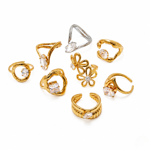 Gold-ring collection with various styles, featuring floral and stone accents, including the Sovereign Flora Ring.