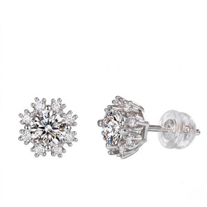 A pair of silver stud earrings with clear round-cut gemstones, shown from the front and side angles on a plain white background. J. Collins Jewelry 