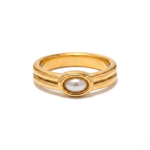Gold band ring with an oval white gemstone inset, minimalist design