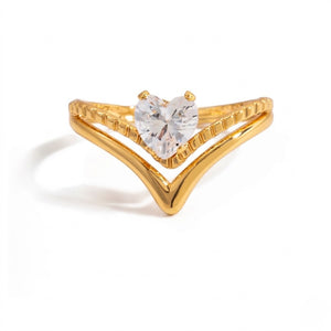 Gold chevron ring with heart-shaped clear gemstone centerpiece