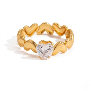 Gold heart solitaire ring with a heart-shaped clear gemstone centerpiece.