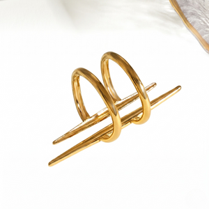 Gold spiral split pillar ring with two cylindrical bars, minimalist style on white background.