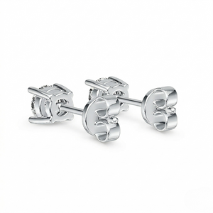 Pair of silver solitaire stud earrings shown from the back to highlight the secure butterfly friction backs and four-prong basket setting. 10K Gold Diamond Earrings 0.418ct - J. Collins Jewelry 