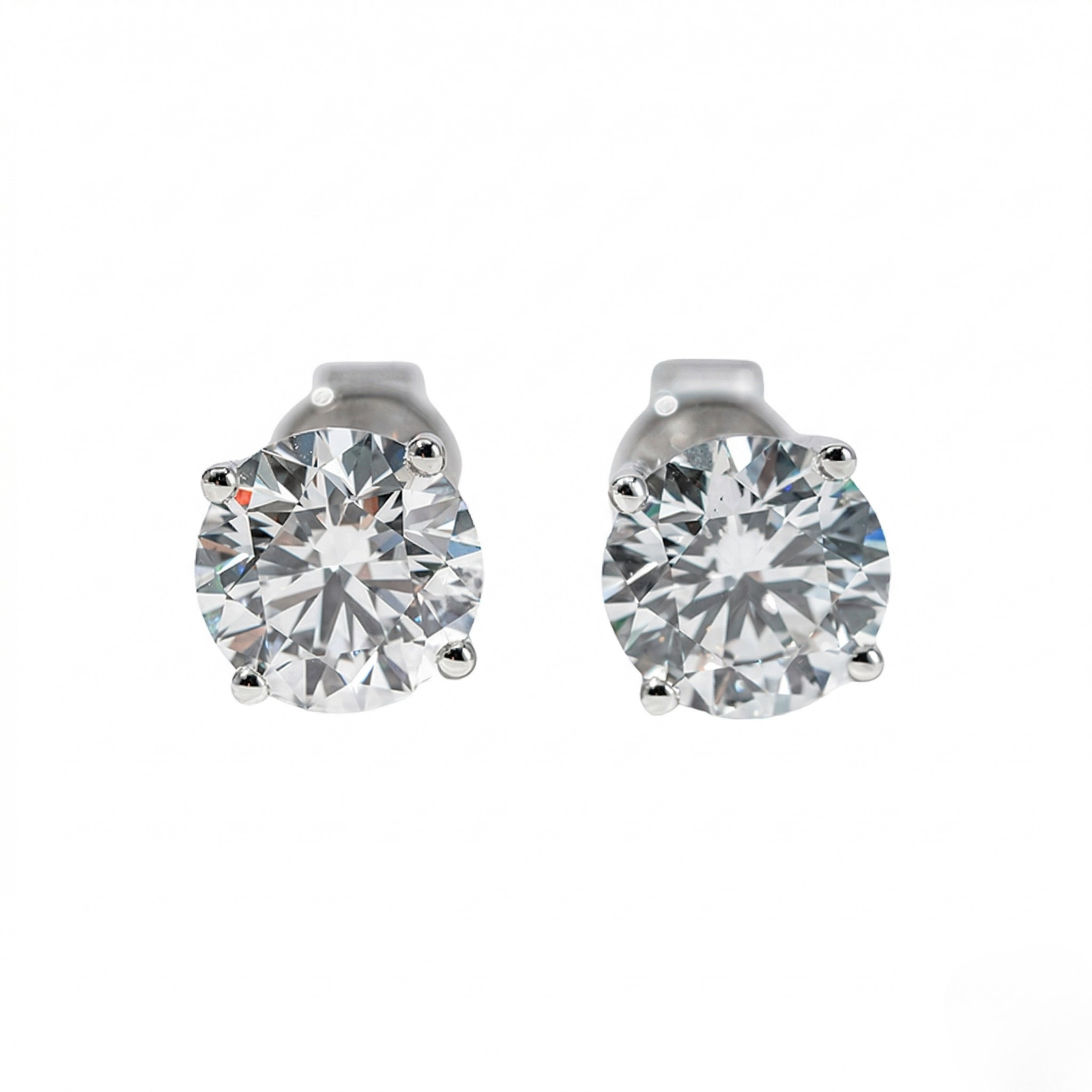 Pair of silver stud earrings with clear gemstones on a white background - 10K White Gold Diamond Earrings - J. Collins Jewelry 