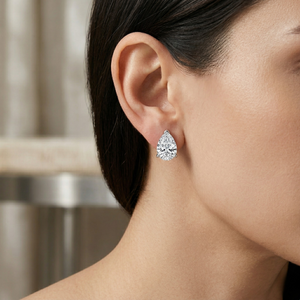 Teardrop-shaped diamond earring worn by a model with a neutral background - 10K White Silver Lab Diamond Earrings 0.549ct by J.Collins Jewelry 