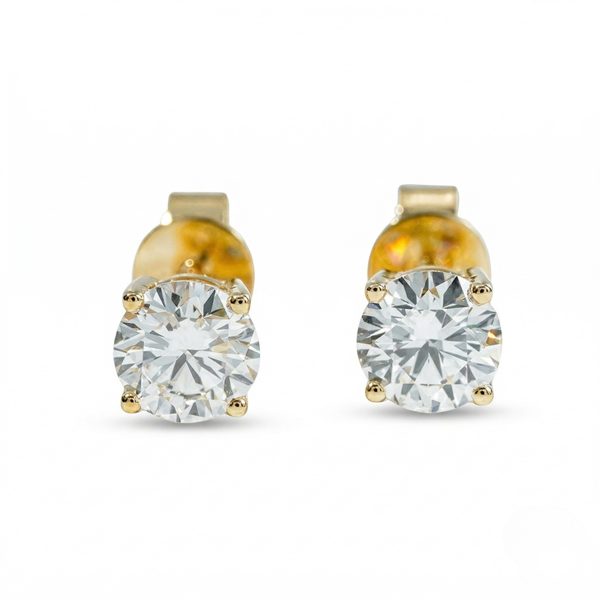 Pair of gold stud earrings with clear gemstones on a white background - 10K Yellow Gold Lab Diamond Earrings 0.531ct by J.Collins Jewelry 