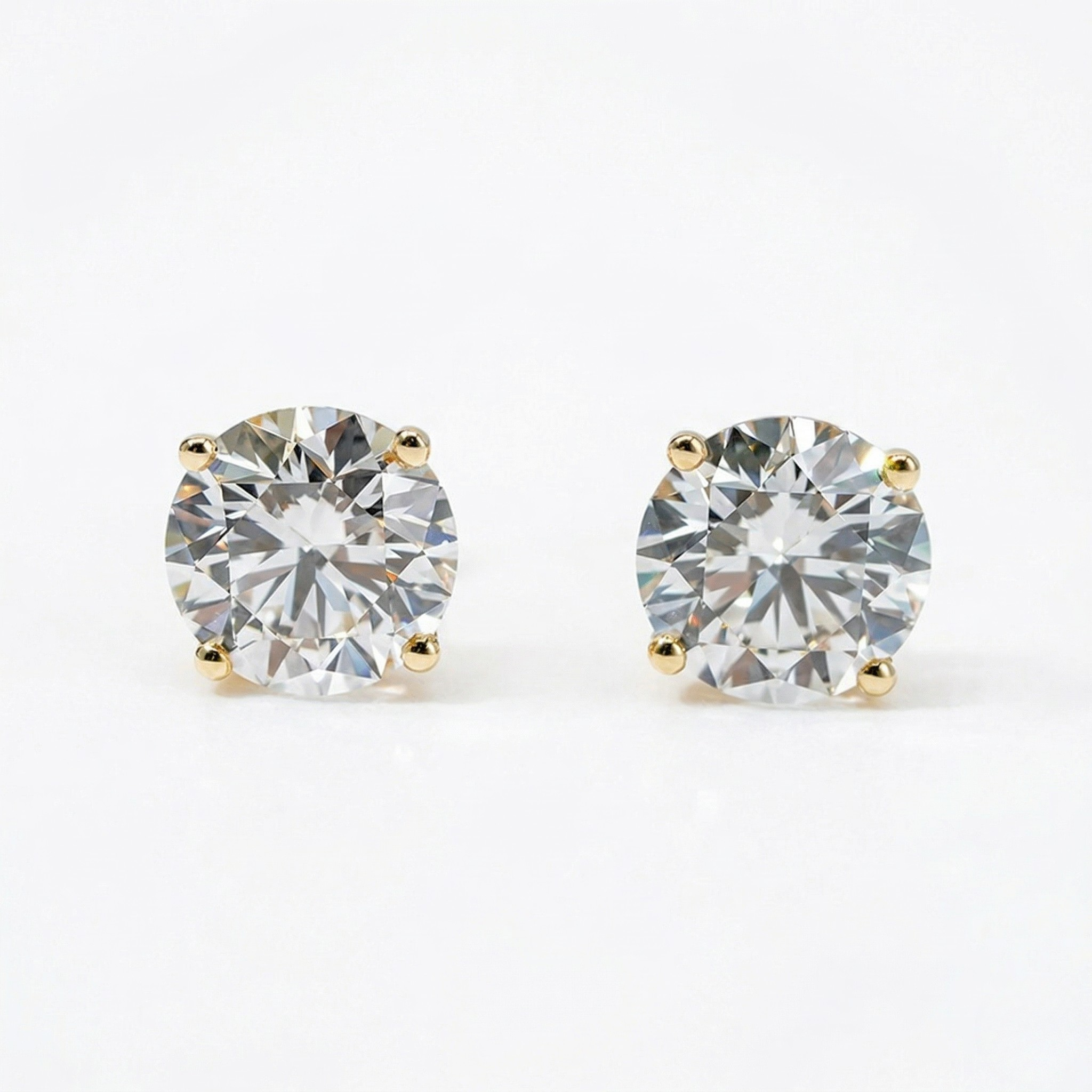 Pair of diamond stud earrings on a white background - 10K Yellow Gold Lab Diamond Earrings Basket 1.1ct - J. Collins Jewelry 