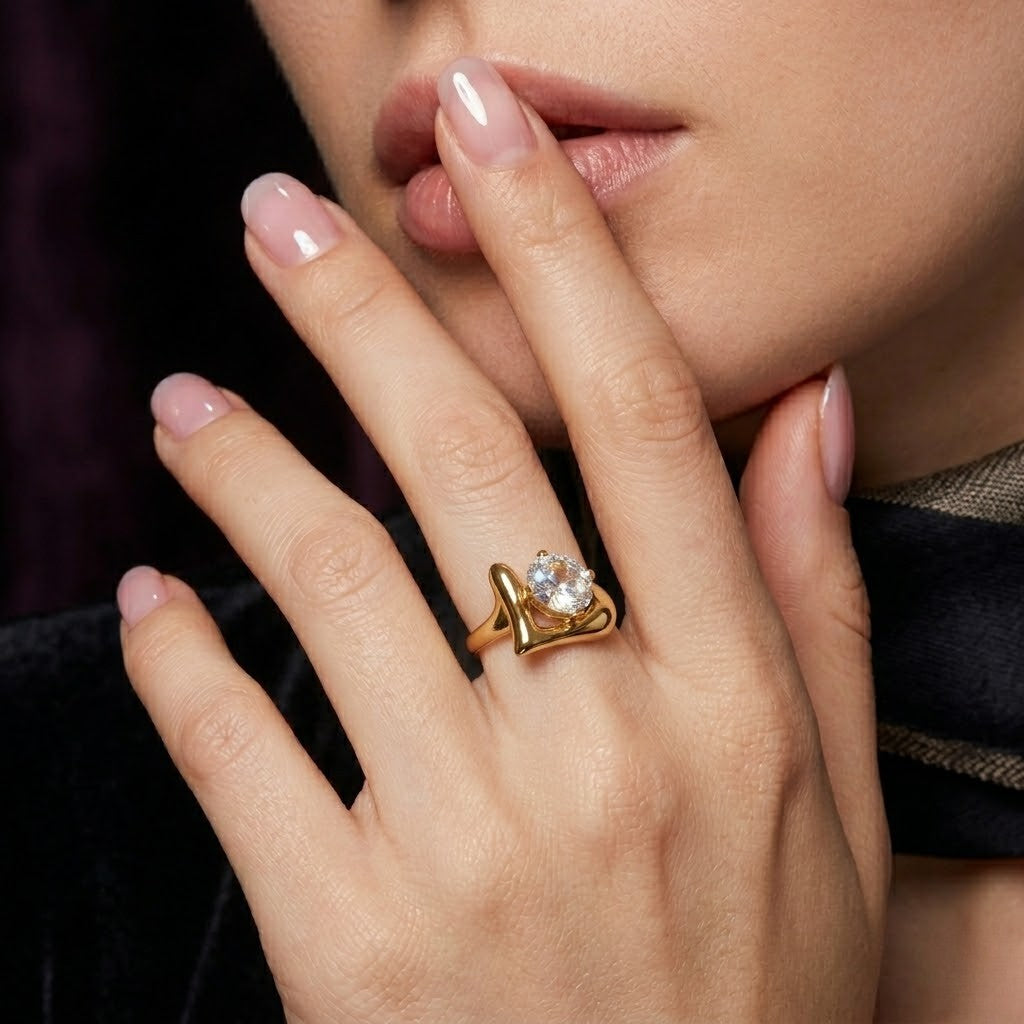 Woman wearing a gold Nova Point Ring with a large clear gemstone, showing elegant design and style.