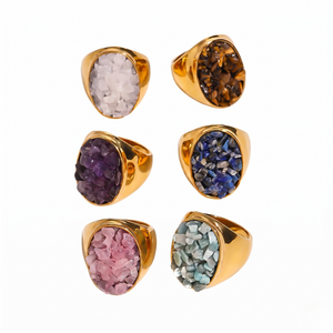 Gold rings with various colored quartz stones: rose, tiger's eye, amethyst, blue, pink, and green.